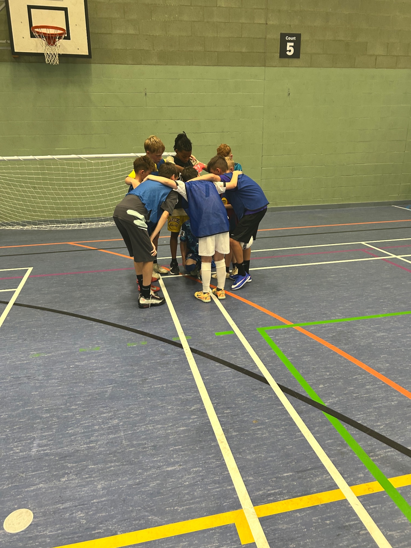 Children huddled together during a Discover Sports party